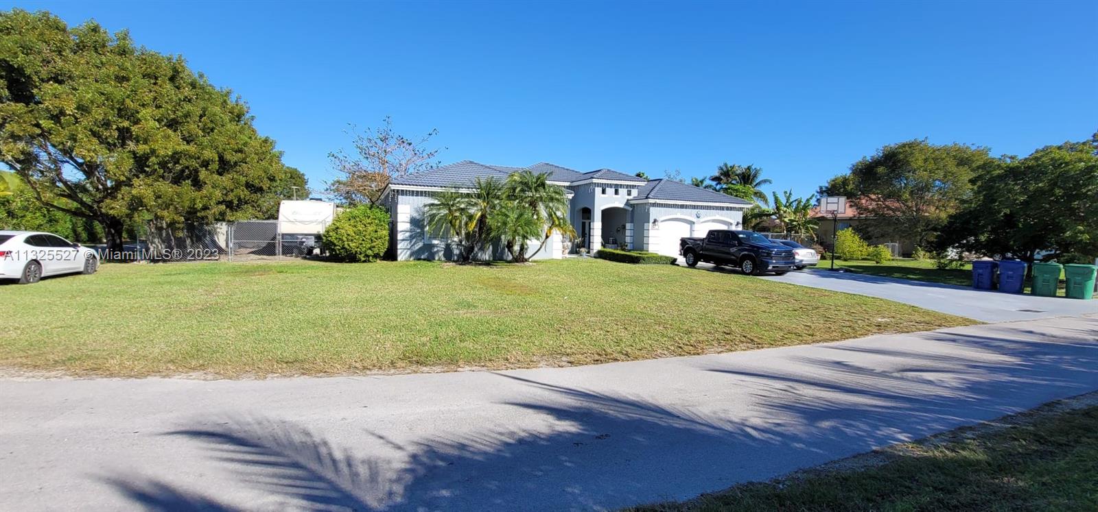20565 Southwest 326th Street Homestead, FL 33030 - Photo 1 of 28 a view of a white house with a big yard and large trees