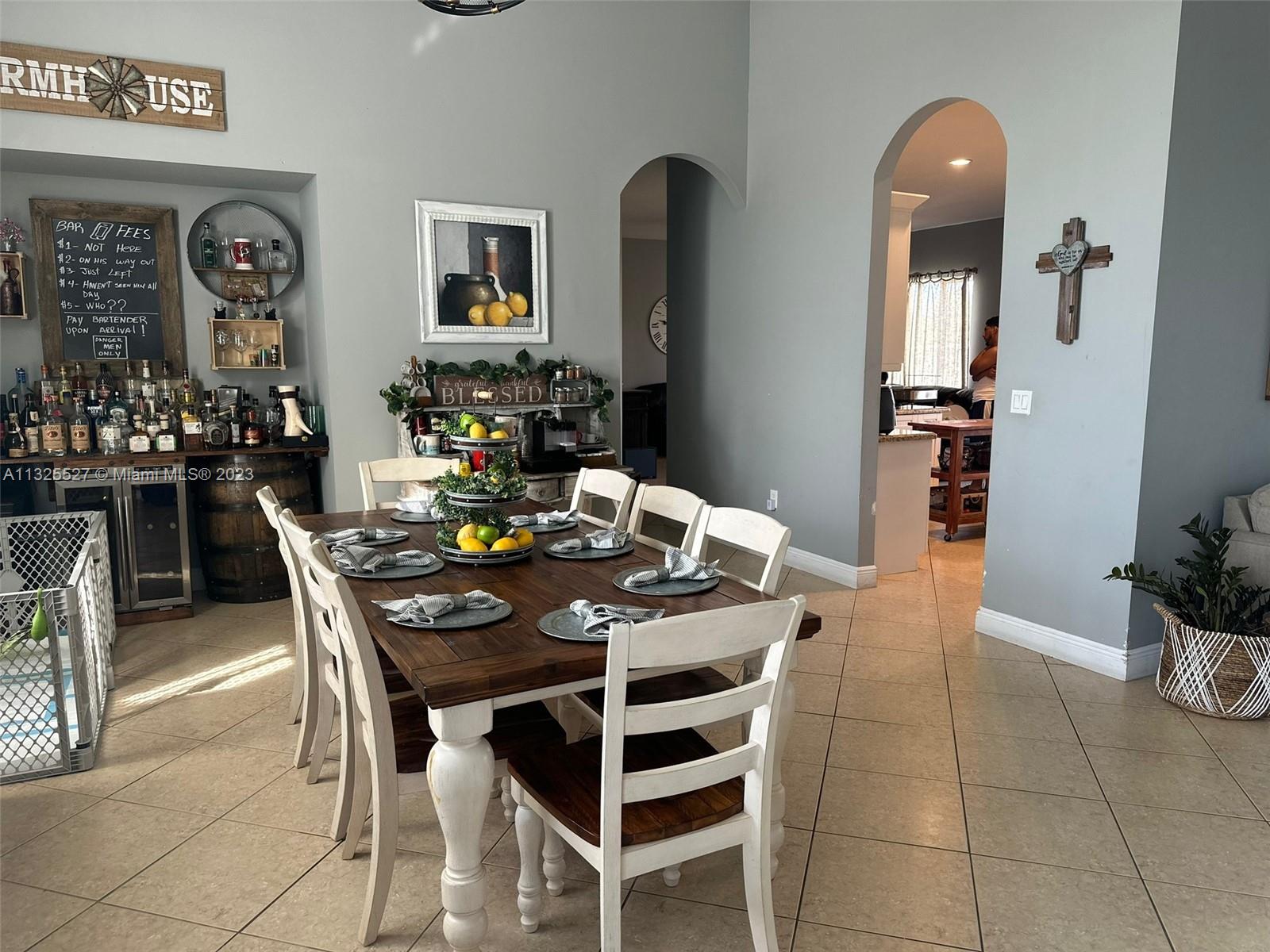 20565 Southwest 326th Street Homestead, FL 33030 - Photo 13 of 28 a view of a dining room with furniture and chandelier