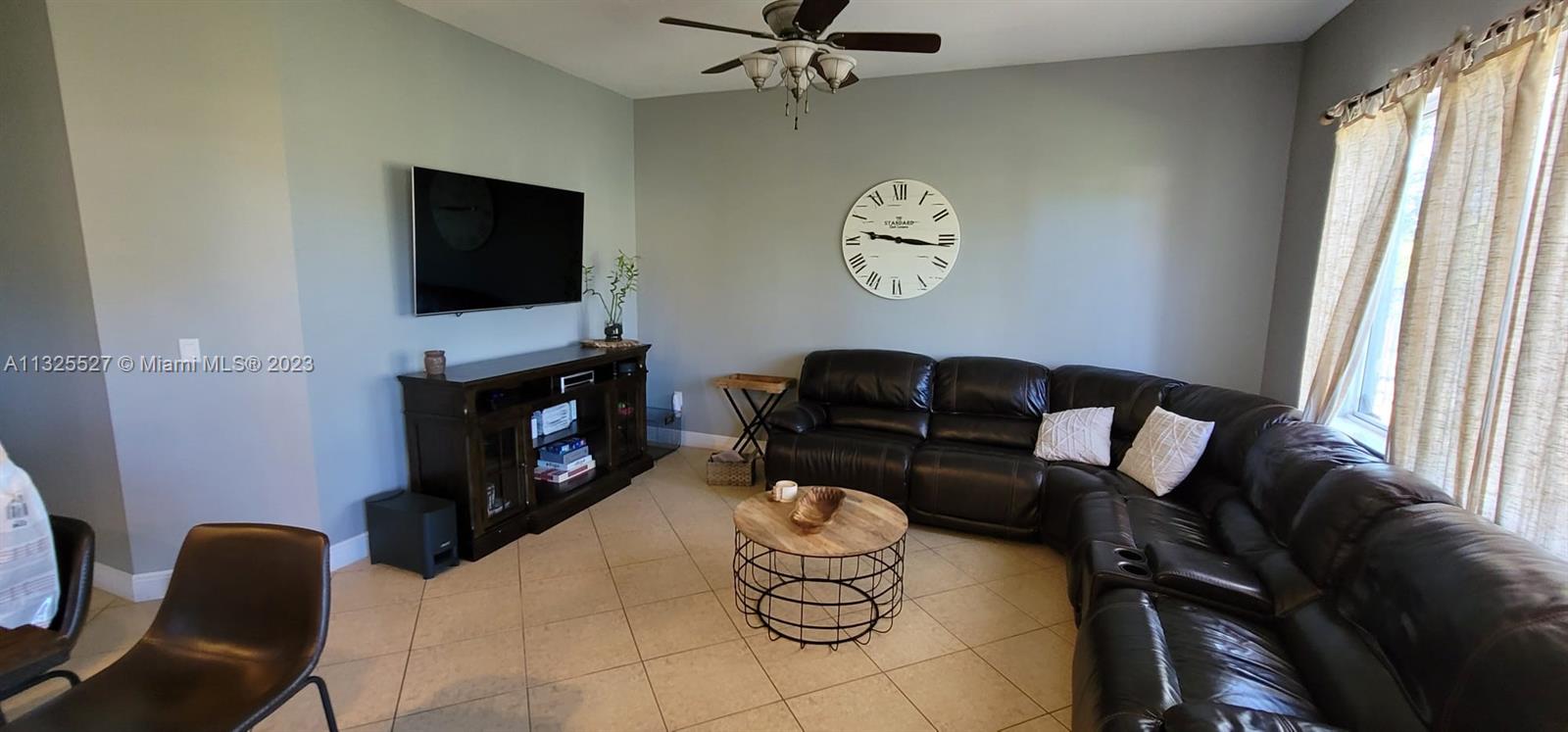 20565 Southwest 326th Street Homestead, FL 33030 - Photo 17 of 28 a living room with furniture a fireplace and a flat screen tv