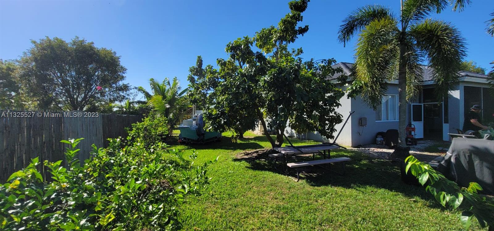 20565 Southwest 326th Street Homestead, FL 33030 - Photo 20 of 28 a view of a garden with a bench