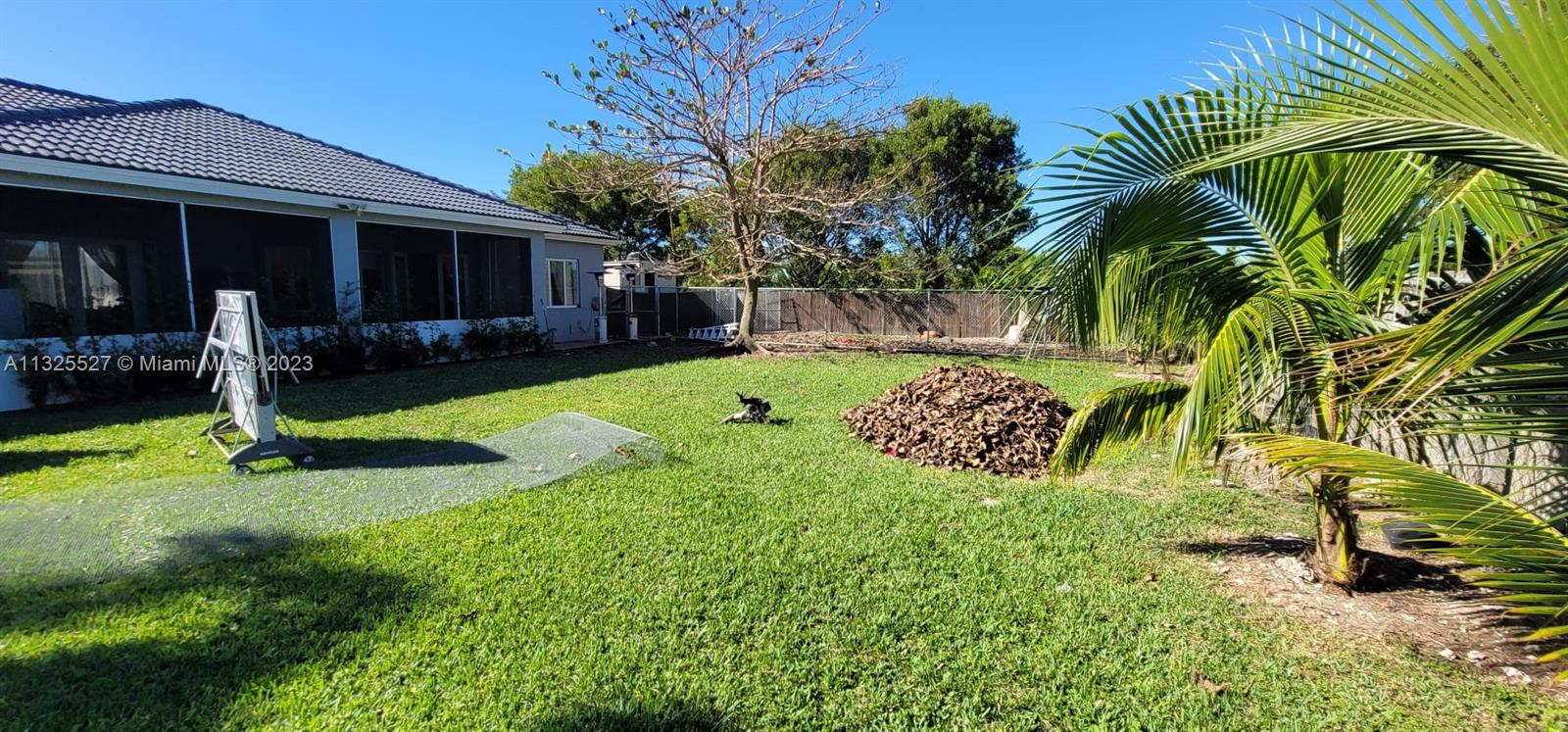 20565 Southwest 326th Street Homestead, FL 33030 - Photo 28 of 28 a view of a backyard with a sitting area and slide