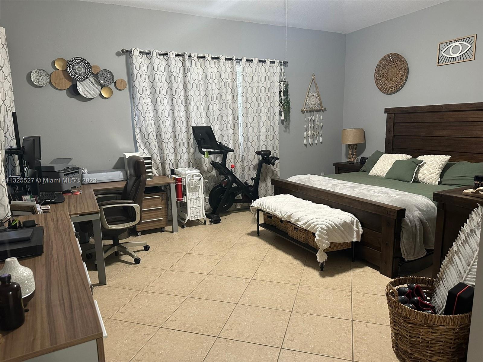 20565 Southwest 326th Street Homestead, FL 33030 - Photo 5 of 28 a bedroom with a bed and a chair