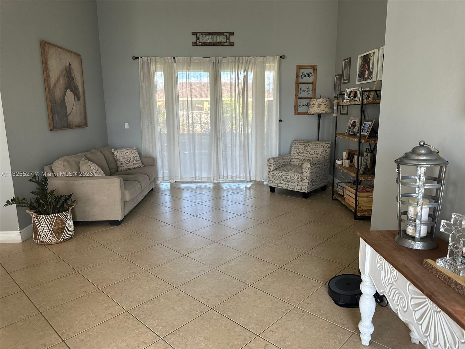 20565 Southwest 326th Street Homestead, FL 33030 - Photo 6 of 28 a living room with furniture and a flat screen tv