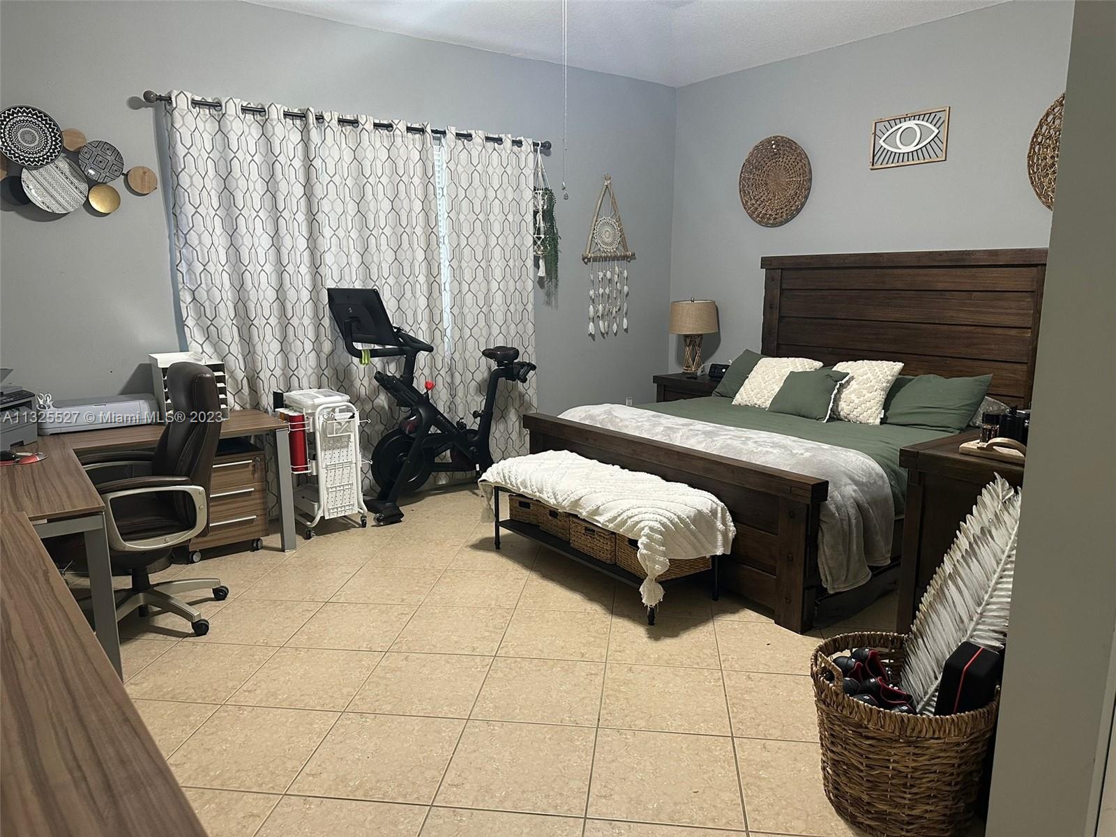 20565 Southwest 326th Street Homestead, FL 33030 - Photo 7 of 28 a bedroom with a bed and a window