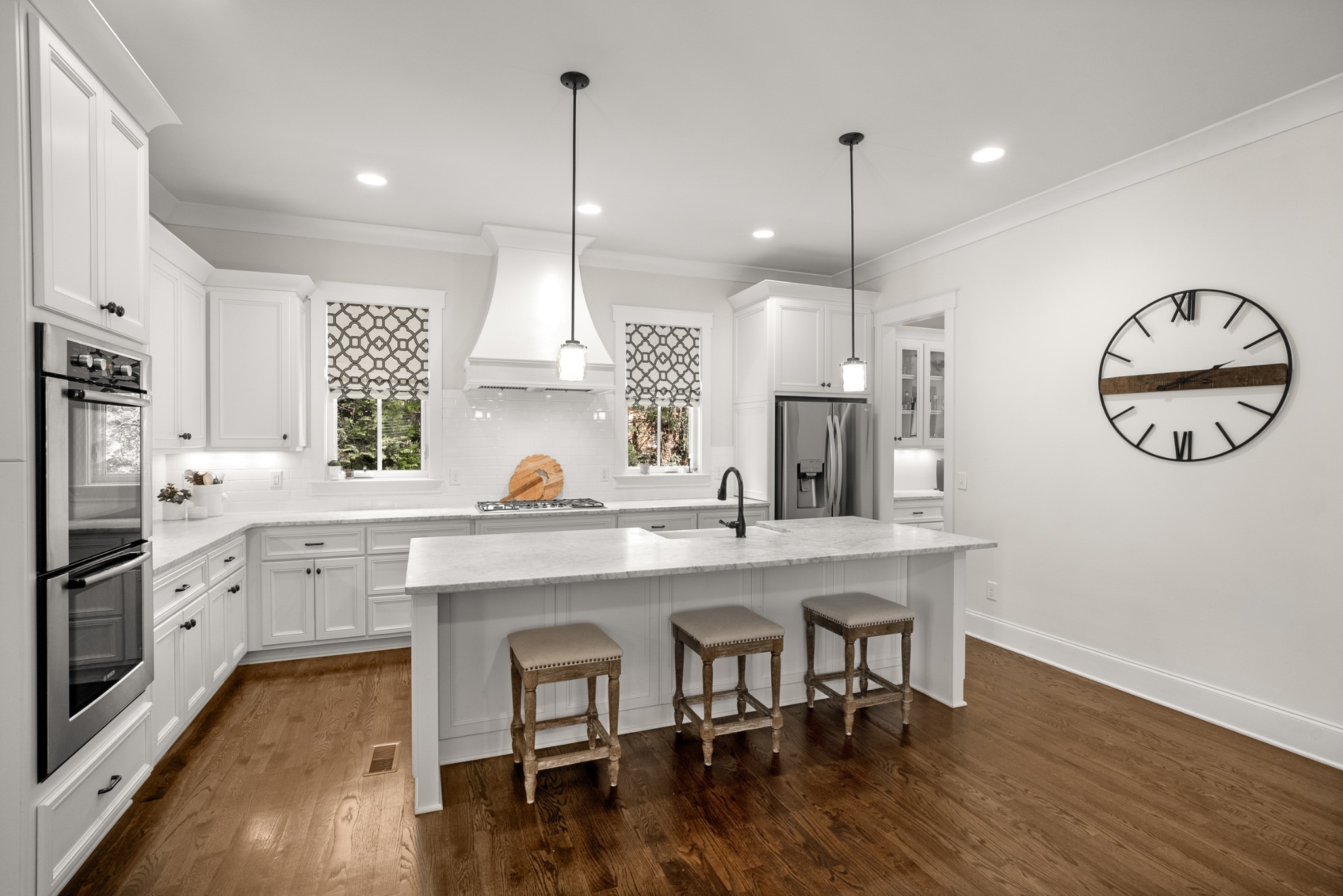 412 Boyd Mill Avenue Franklin, TN 37064 - Photo 11 of 53 a kitchen with stainless steel appliances granite countertop a stove a sink a refrigerator and a dining table with wooden floor