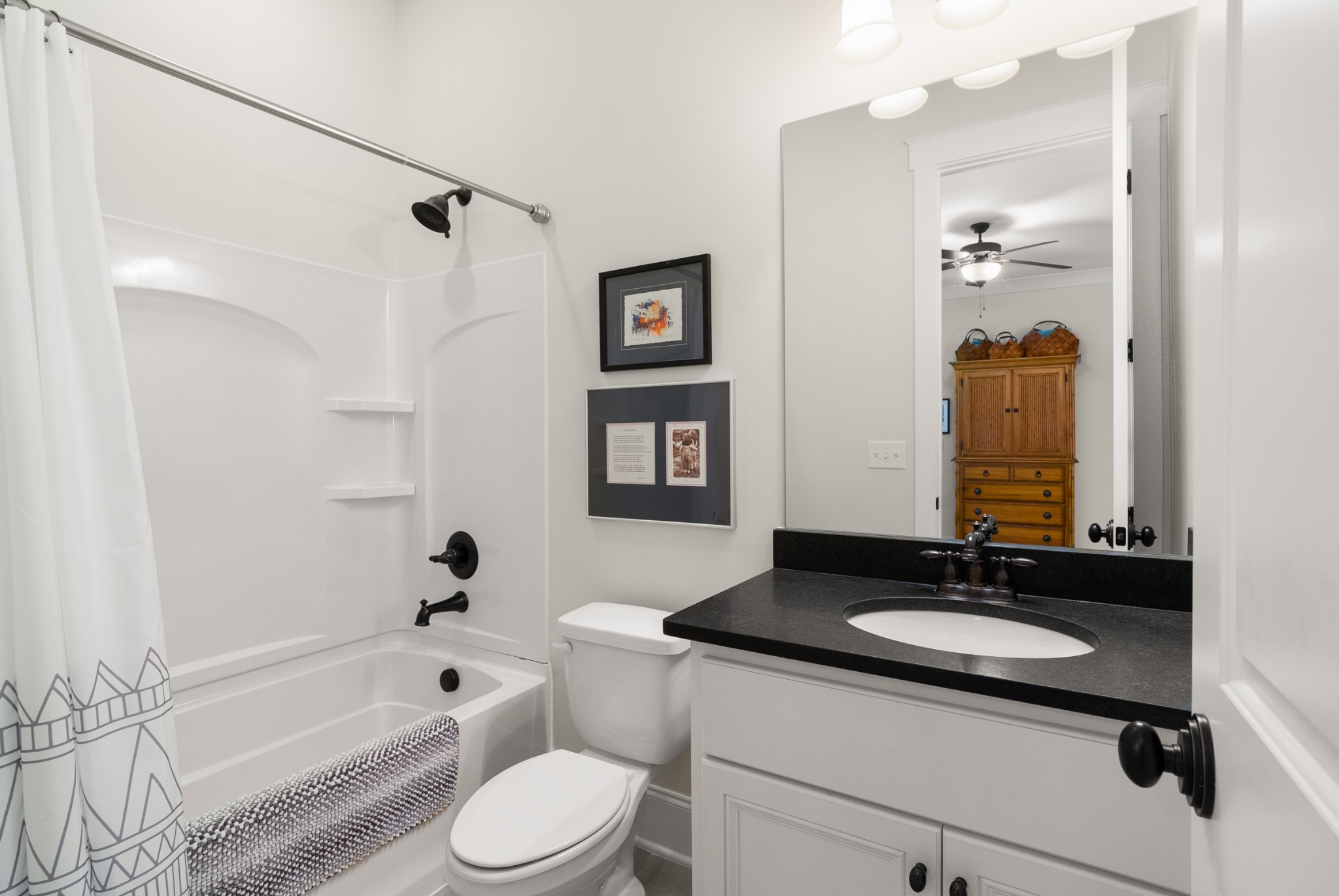 412 Boyd Mill Avenue Franklin, TN 37064 - Photo 31 of 53 a bathroom with a granite countertop sink toilet a mirror a bathtub and shower