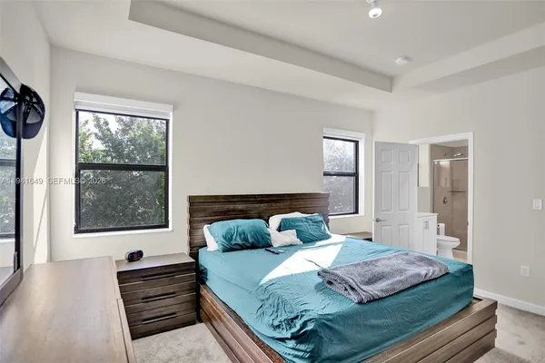 a bedroom with a bed and a window with outer view