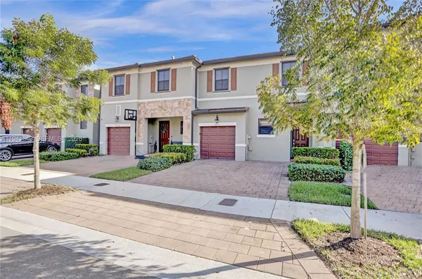 a front view of a house with a yard and a garage