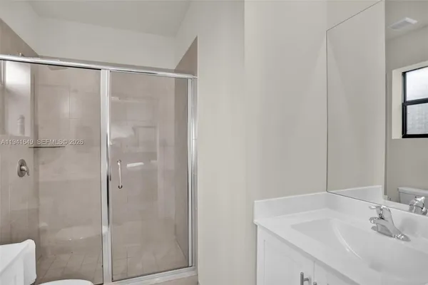 a bathroom with a shower and sink