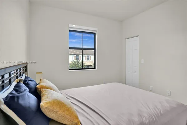 a bedroom with a bed and balcony