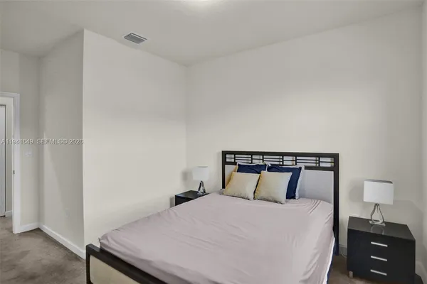 a bedroom with a bed and a lamp