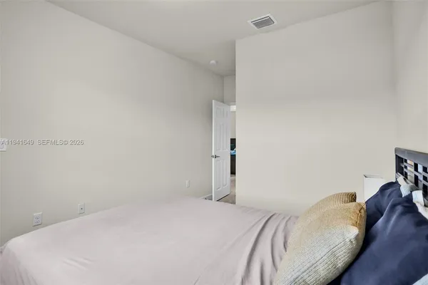 a bedroom with a bed and a rug