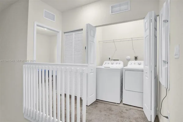 a utility room with dryer and washer