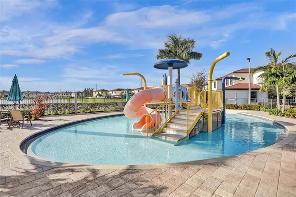 a view of a swimming pool with a table and chairs