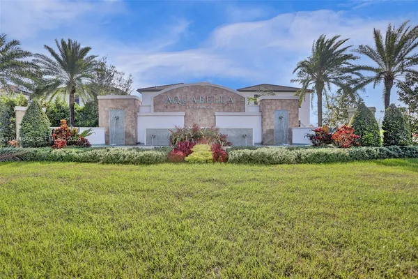 a front view of house with small garden and palm trees