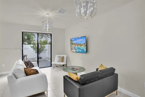 a living room with furniture and a chandelier