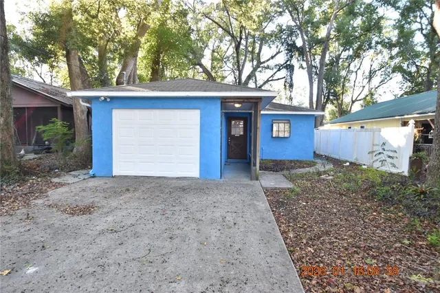 a view of a house with a yard and garage