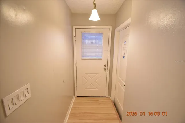 a view of a hallway to rooms