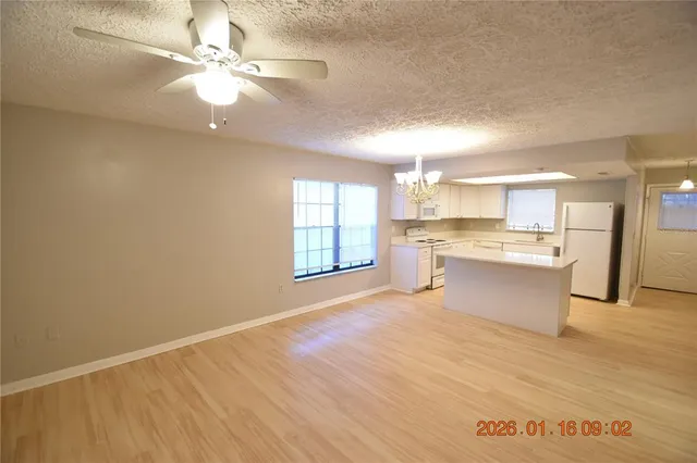 a view of kitchen with granite countertop cabinets and outdoor space