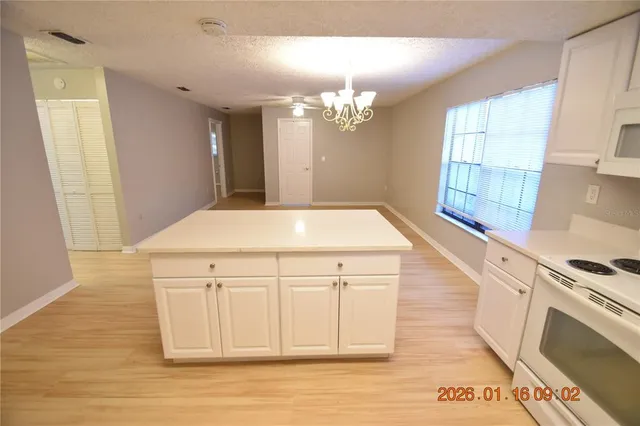 a kitchen with a cabinets and chandelier