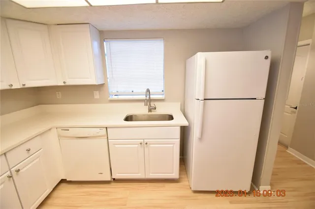 a white refrigerator freezer sitting inside of a kitchen