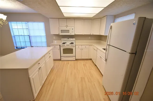 a kitchen with a sink a refrigerator a washer and dryer