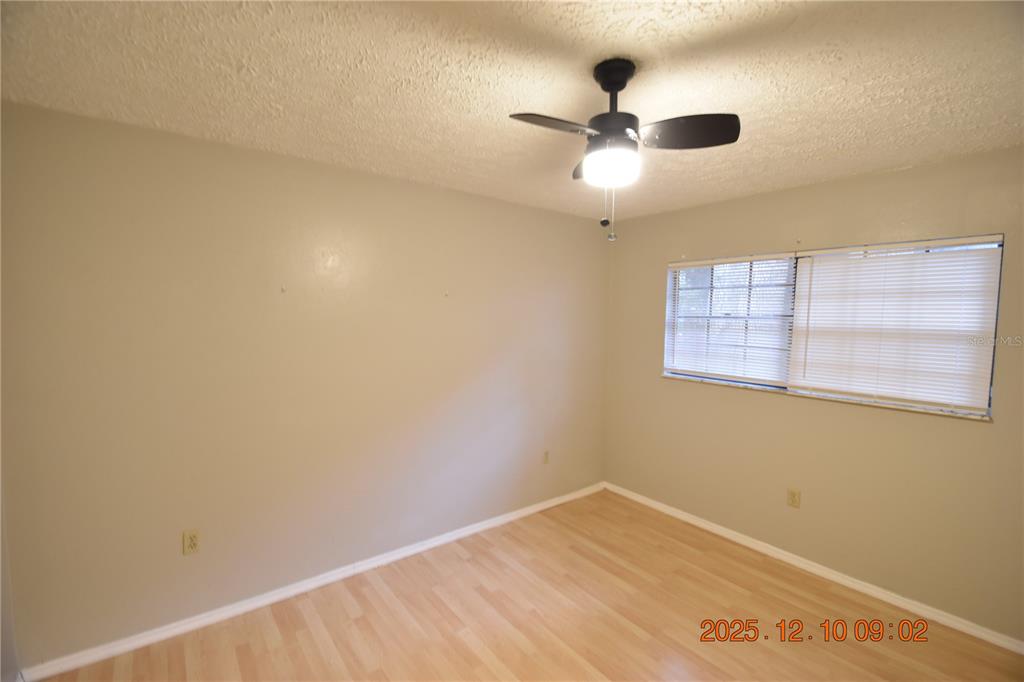 5824 Grey Street New Port Richey, FL 34652 - Photo 21 of 28 an empty room with a window and a fan