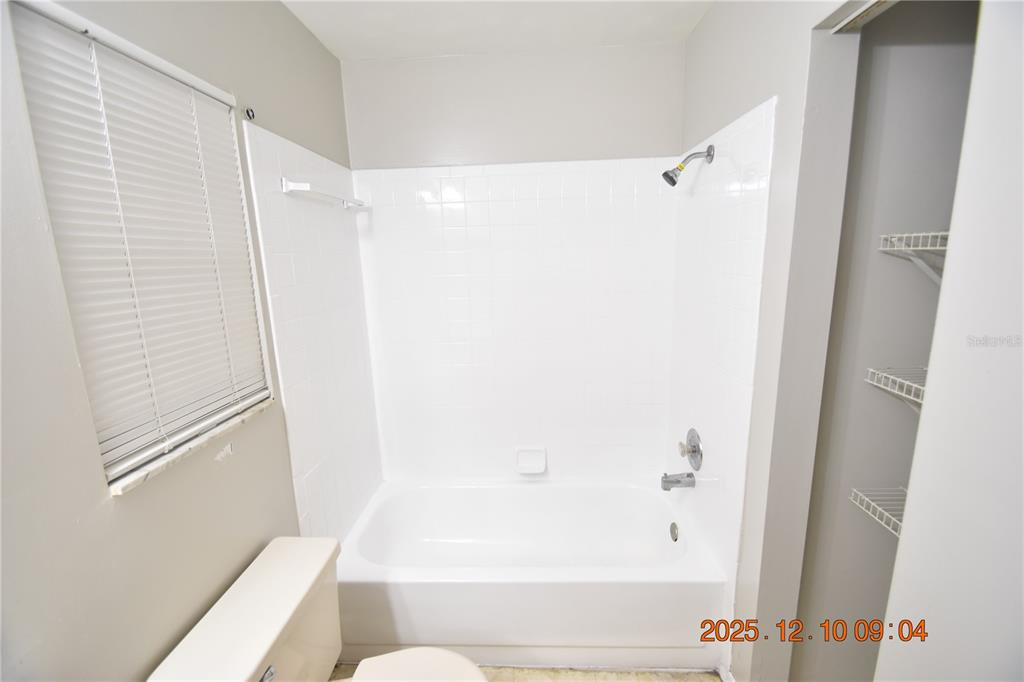 5824 Grey Street New Port Richey, FL 34652 - Photo 26 of 28 a bathroom with a shower and a tub