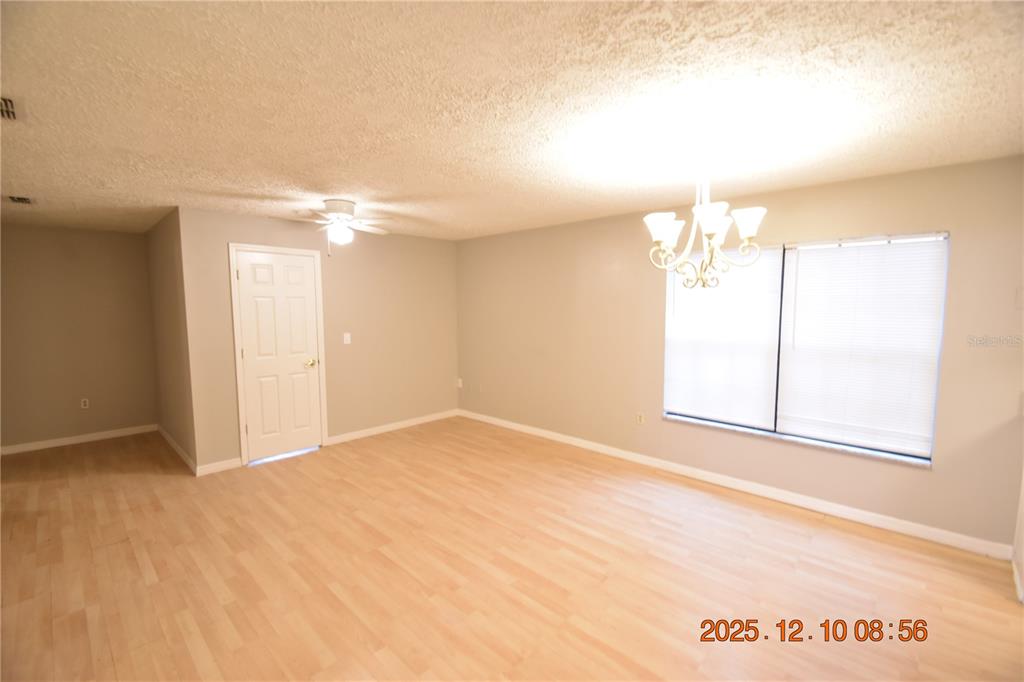 5824 Grey Street New Port Richey, FL 34652 - Photo 3 of 28 en empty room with windows and ceiling fan