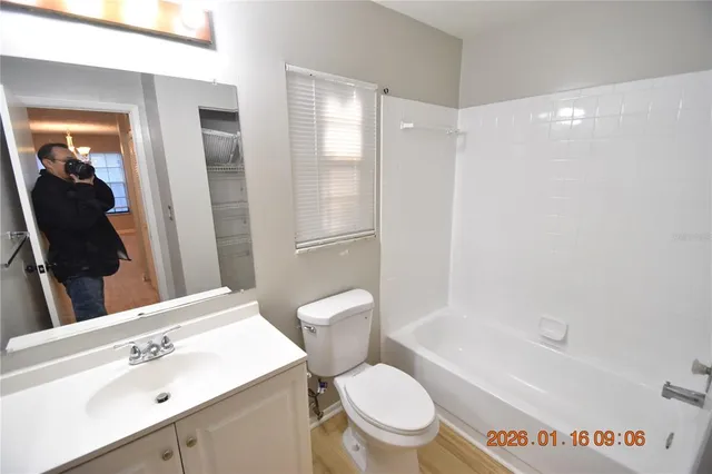 a white toilet sitting next to a bathroom sink