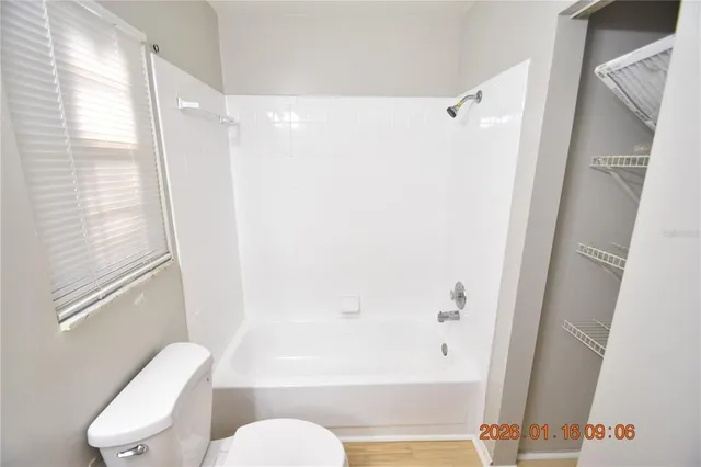 a bathroom with a shower a toilet and a shower