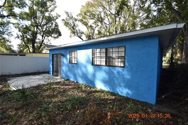 a view of backyard of house with wooden floor