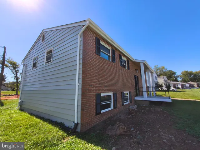 a kitchen with granite countertop a refrigerator and a sink