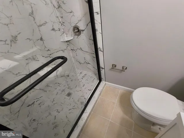 an empty room with wooden floor and white door