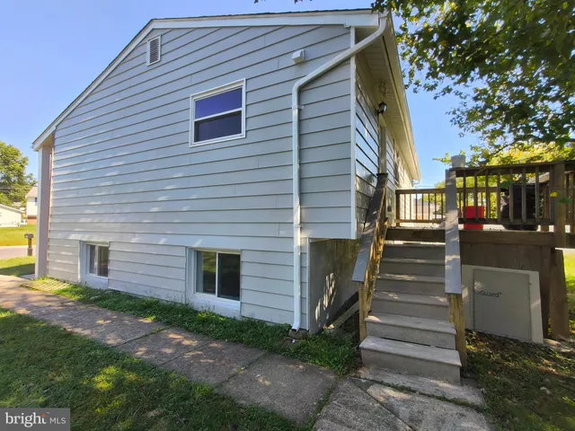 a backyard of a house with wooden floor and fence