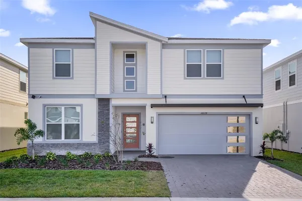 a front view of a house with a yard and garage