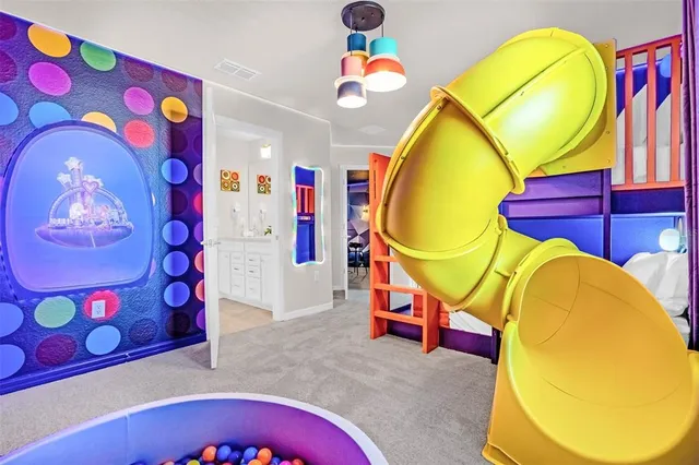 a bedroom with bed and a chandelier