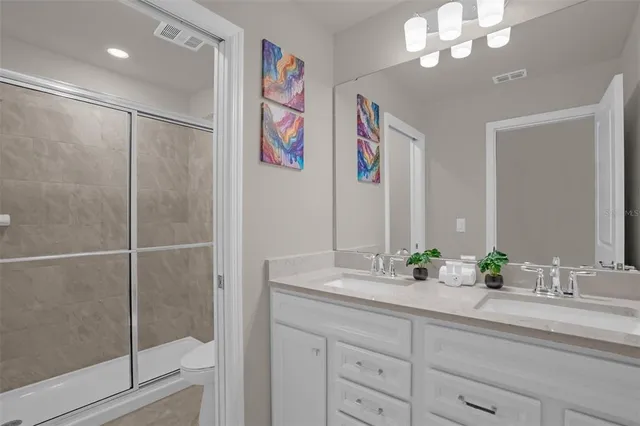 a bedroom with a large bed and a flat tv screen