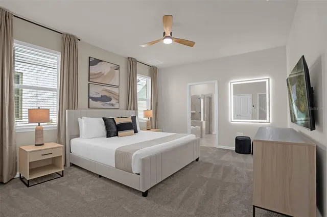 a bathroom with a granite countertop sink a toilet a mirror and shower