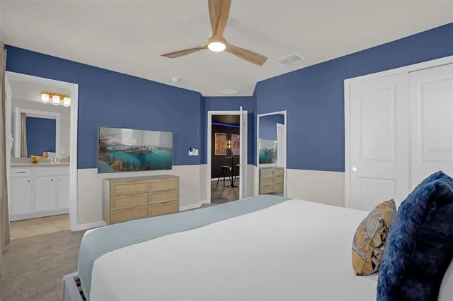 a bedroom with a large bed and a chandelier