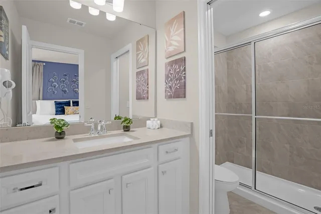 a bedroom with a bed a dresser and a window