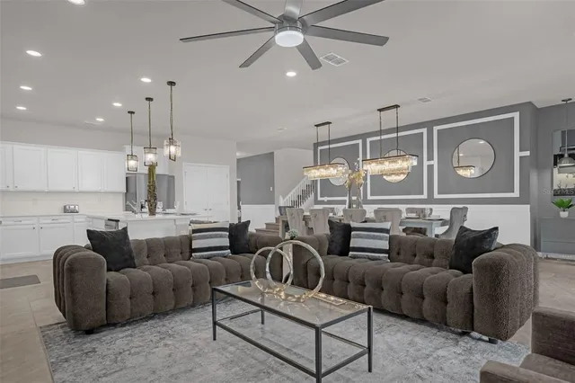 a living room with furniture a rug and white walls