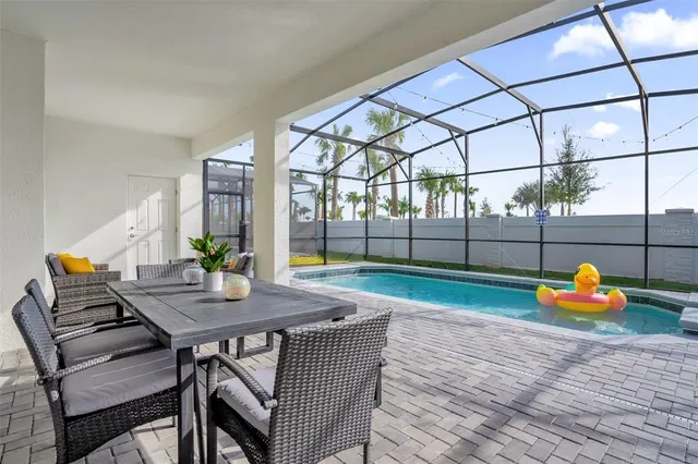 a view of a patio with a table and chairs