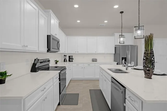 a kitchen with a sink stove and cabinets