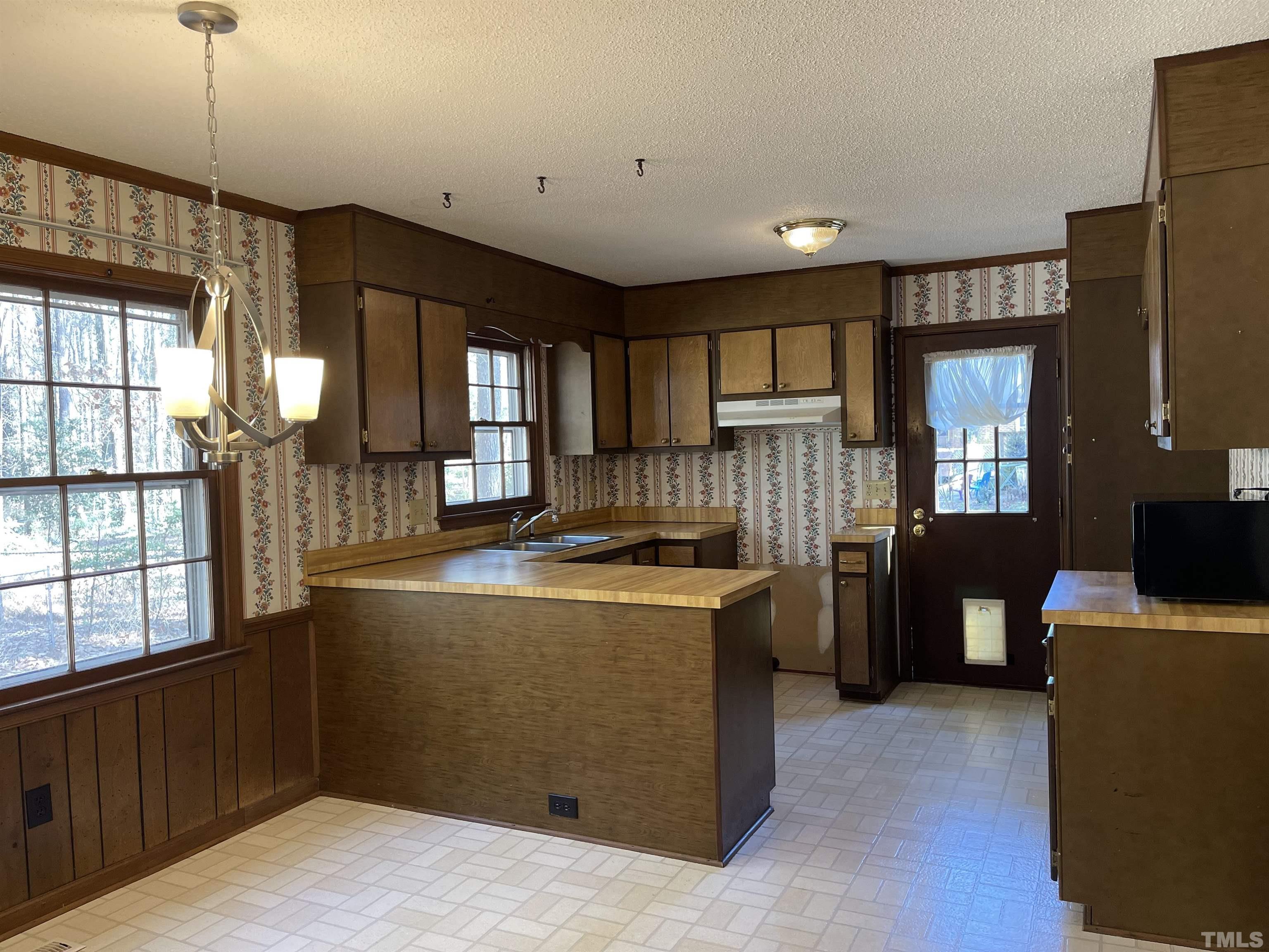 1429 Clermont Road Durham, NC 27713 - Photo 3 of 10 a kitchen with a stove a refrigerator and a refrigerator
