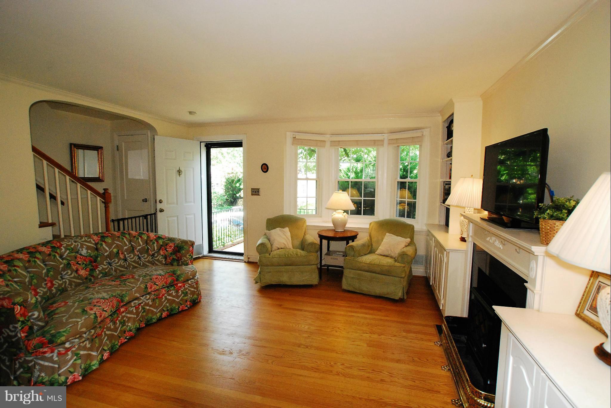 195 Stanmore Road Baltimore, MD 21212 - Photo 7 of 22 a living room with furniture a flat screen tv and a fireplace