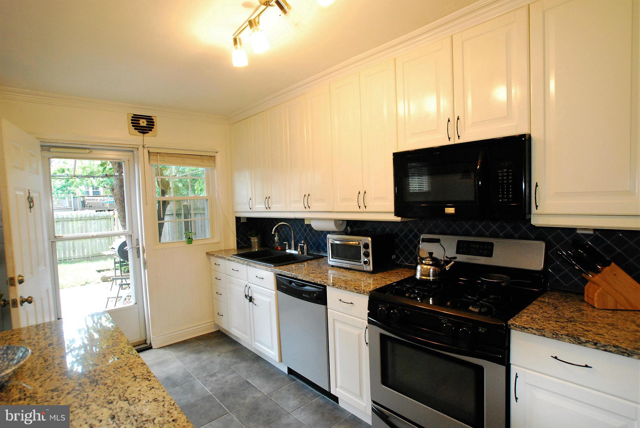 195 Stanmore Road Baltimore, MD 21212 - Photo 9 of 22 a kitchen with a stove and a microwave