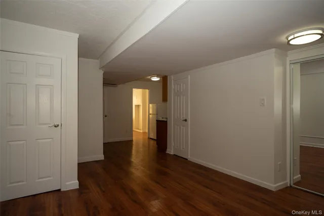 a view of hallway with wooden floor