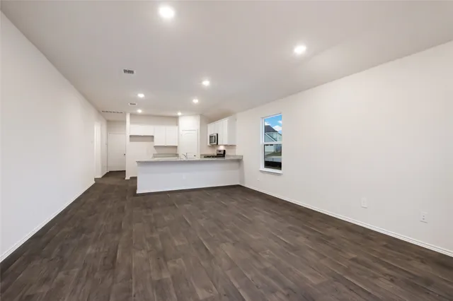 a view of a kitchen with a sink and wooden floor