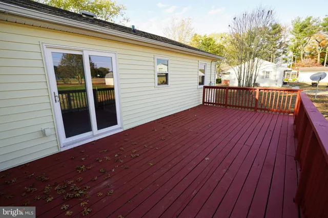 a view of a house with wooden deck